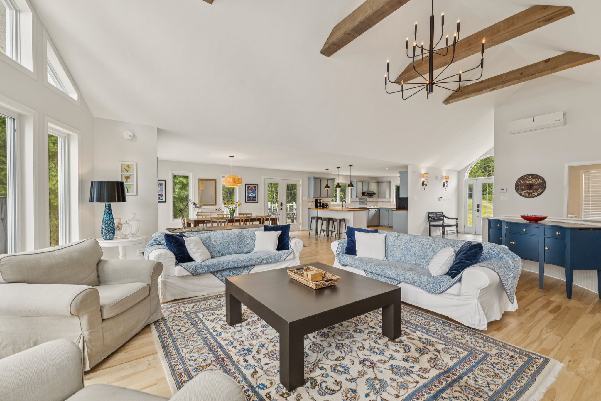 Cathedral ceiling living room with wood-burning stove and wraparound terrace at Chalet Beach House